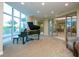 Relaxing music room with a grand piano and large windows at 340 S Palm Ave # 15, Sarasota, FL 34236