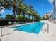 Resort-style pool with lounge chairs and palm trees at 340 S Palm Ave # 15, Sarasota, FL 34236