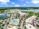 Aerial view of a community with lake views, shopping, and lush landscaping at 7710 Lake Vista Ct # 404, Lakewood Ranch, FL 34202