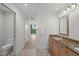 Bathroom with granite countertops, double sinks, and a view into the hallway at 7710 Lake Vista Ct # 404, Lakewood Ranch, FL 34202