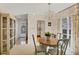 Charming dining room with a round table, chandelier, and view to kitchen at 6033 Arlene Way # 3, Bradenton, FL 34207