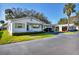 Exterior view of a charming single-story home with a carport and lush landscaping at 6033 Arlene Way # 3, Bradenton, FL 34207
