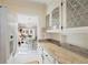 White kitchen cabinets, granite countertops, and view into dining area at 6033 Arlene Way # 3, Bradenton, FL 34207