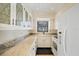 View of a galley kitchen with granite countertops and white cabinets at 6033 Arlene Way # 3, Bradenton, FL 34207