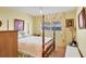Bedroom with a four-poster bed and window with drapes at 6033 Arlene Way # 3, Bradenton, FL 34207