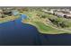 Aerial view of community golf course with lake and homes at 26356 Nadir Rd # 101, Punta Gorda, FL 33983