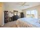 Spacious bedroom with dresser, mirror, and sliding glass doors leading to a scenic view at 26356 Nadir Rd # 101, Punta Gorda, FL 33983