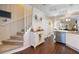 Carpeted stairs in a light-colored home with adjacent kitchen at 26356 Nadir Rd # 101, Punta Gorda, FL 33983