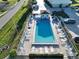 Community pool with surrounding patio and lounge chairs at 26356 Nadir Rd # 101, Punta Gorda, FL 33983