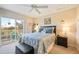 Spacious bedroom with a king-size bed and access to a private balcony overlooking a golf course at 26356 Nadir Rd # 101, Punta Gorda, FL 33983