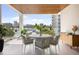 Outdoor balcony dining area with modern furniture and marina views at 509 Golden Gate Pt # 2, Sarasota, FL 34236