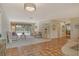 Spacious living room with tiled floors, comfy furniture, and pool view at 328 Eden Dr, Englewood, FL 34223