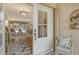 White front door opens to a view of the living room and tiled entryway at 328 Eden Dr, Englewood, FL 34223