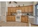 Well-equipped kitchen with light wood cabinets and granite countertops at 328 Eden Dr, Englewood, FL 34223