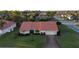 Aerial view of single-Gathering house with tile roof, two-car garage, and landscaped yard at 328 Eden Dr, Englewood, FL 34223