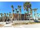 Modern beach access building with palm trees at 328 Eden Dr, Englewood, FL 34223