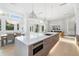 Spacious kitchen island with stainless appliances, pendant lighting, and open view to the living room and dining area at 2512 Jefferson Cir, Sarasota, FL 34239