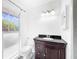 Bathroom with toilet, vanity, and window at 107 Los Cedros Dr, Anna Maria, FL 34216