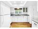 White kitchen features granite countertops and a window overlooking the backyard at 107 Los Cedros Dr, Anna Maria, FL 34216