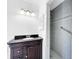 Bathroom with dark vanity, shower, and tiled walls at 107 Los Cedros Dr, Anna Maria, FL 34216