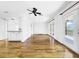 Hardwood floor living room with kitchen and deck access at 107 Los Cedros Dr, Anna Maria, FL 34216