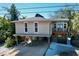 Elevated home with parking underneath and a small balcony at 107 Los Cedros Dr, Anna Maria, FL 34216