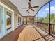 Large screened porch with wood deck and fans at 107 Los Cedros Dr, Anna Maria, FL 34216