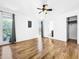 Bedroom with hardwood floors, ceiling fan, and access to bathroom at 107 Los Cedros Dr, Anna Maria, FL 34216