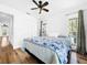 Bedroom with hardwood floors, ceiling fan, and view from window at 107 Los Cedros Dr, Anna Maria, FL 34216