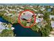 Aerial view of waterfront home with large deck and lush landscaping at 107 Los Cedros Dr, Anna Maria, FL 34216