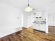 Bright dining area with hardwood floors and kitchen access at 107 Los Cedros Dr, Anna Maria, FL 34216