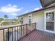 Deck with wooden railings and view of the neighborhood at 107 Los Cedros Dr, Anna Maria, FL 34216