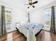 Spacious bedroom with hardwood floors and ceiling fan at 107 Los Cedros Dr, Anna Maria, FL 34216