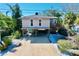 Elevated home with parking underneath and a small balcony at 107 Los Cedros Dr, Anna Maria, FL 34216