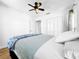 Bright bedroom with hardwood floors, ceiling fan, and ample closet space at 107 Los Cedros Dr, Anna Maria, FL 34216