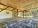 Covered patio area under the house with tiled flooring and gravel at 107 Los Cedros Dr, Anna Maria, FL 34216