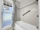 Bathroom with shower/tub and window at 107 Los Cedros Dr, Anna Maria, FL 34216