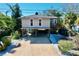 Elevated home with parking underneath and a small balcony at 107 Los Cedros Dr, Anna Maria, FL 34216