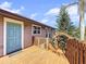 Deck with wooden railings, stairs, and teal door access to home at 107 Los Cedros Dr, Anna Maria, FL 34216