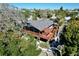 Elevated view of house, deck, and surrounding trees at 107 Los Cedros Dr, Anna Maria, FL 34216