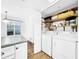 Laundry room with washer, dryer, and shelving at 107 Los Cedros Dr, Anna Maria, FL 34216