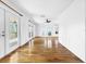 Long hallway with hardwood floors and access to multiple rooms and deck at 107 Los Cedros Dr, Anna Maria, FL 34216