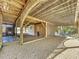 Under-deck storage area with gravel flooring and wooden lattice at 107 Los Cedros Dr, Anna Maria, FL 34216
