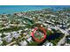 Aerial view of waterfront home nestled in tropical landscape at 107 Los Cedros Dr, Anna Maria, FL 34216