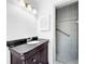Bathroom with dark vanity, shower, and tiled walls at 107 Los Cedros Dr, Anna Maria, FL 34216