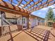Spacious deck with pergola, overlooking the water and home's exterior at 107 Los Cedros Dr, Anna Maria, FL 34216