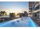 Infinity pool with lounge chairs and stunning sunset views at 668 Quay Commons # 506, Sarasota, FL 34236