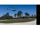 An idyllic aerial shot of the property with a helicopter overhead in a tranquil setting at 34452 Singletary Rd, Myakka City, FL 34251