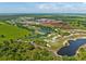 Aerial view of a golf course community under construction with large ponds at 34452 Singletary Rd, Myakka City, FL 34251