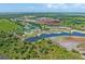 Aerial view of a golf course community under construction with large ponds at 34452 Singletary Rd, Myakka City, FL 34251